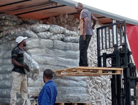 Forklift loading baled stock onto a truck